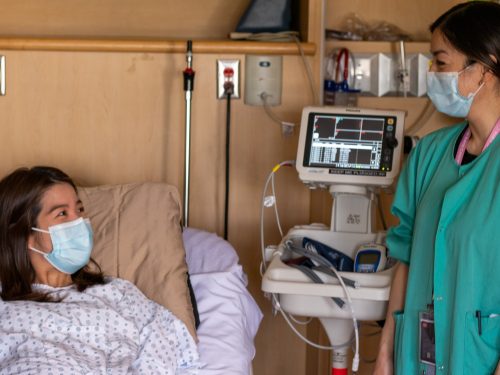 Nurse and mother talking to one another.